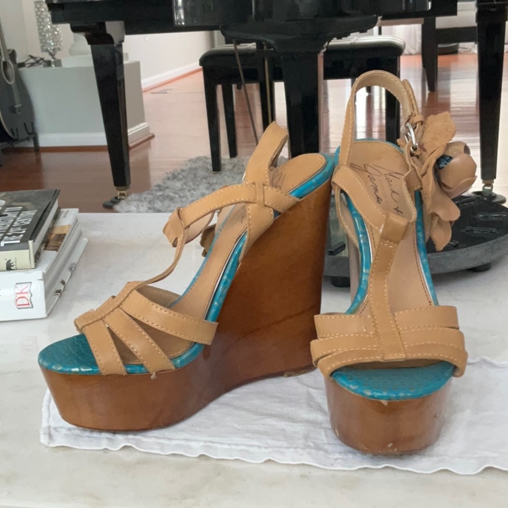 Genuine leather wooden platform sandals with floral accents.